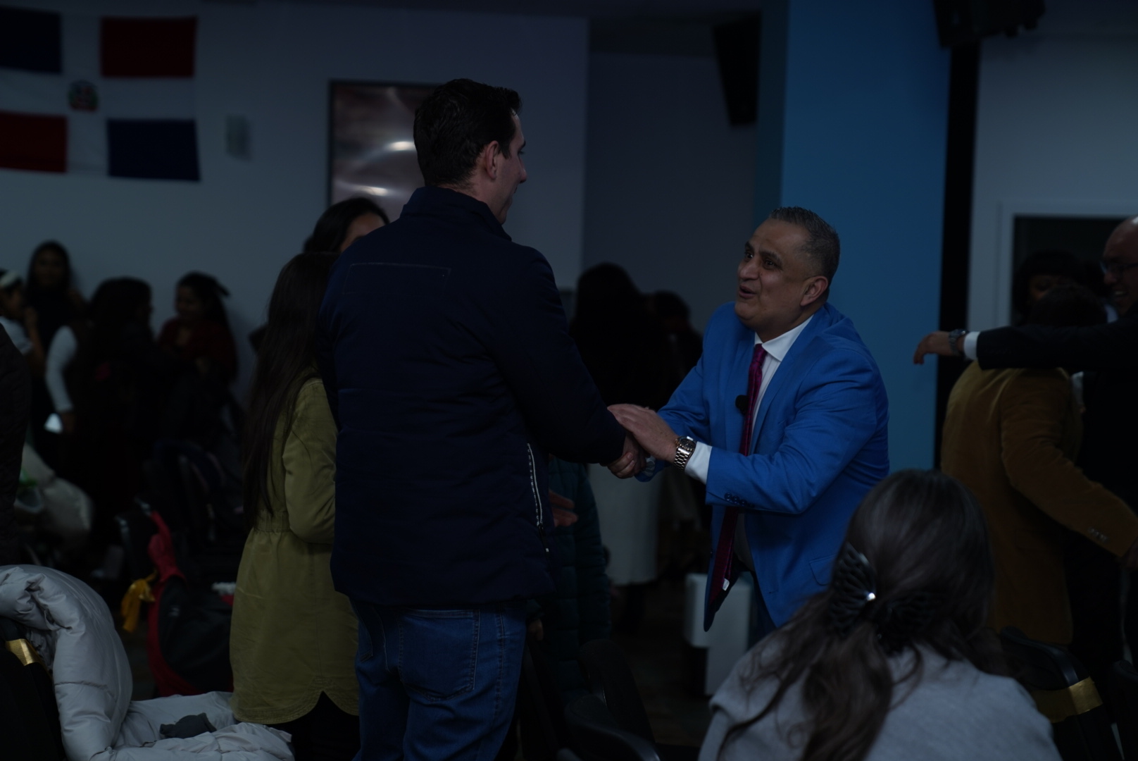 Pastor recibiendo con calidez a un visitante en la iglesia